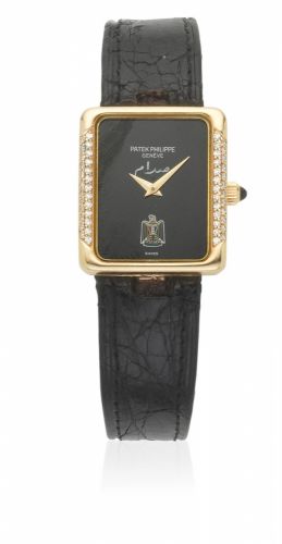 Patek Philippe. A lady's 18K gold and diamond set manual wind rectangular wristwatch with Middle Eastern emblem