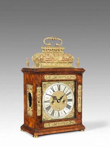 A walnut veneered quarter repeating basket top table clock