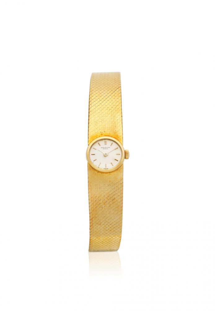 Patek Philippe. A lady's 18K gold manual wind bracelet watch