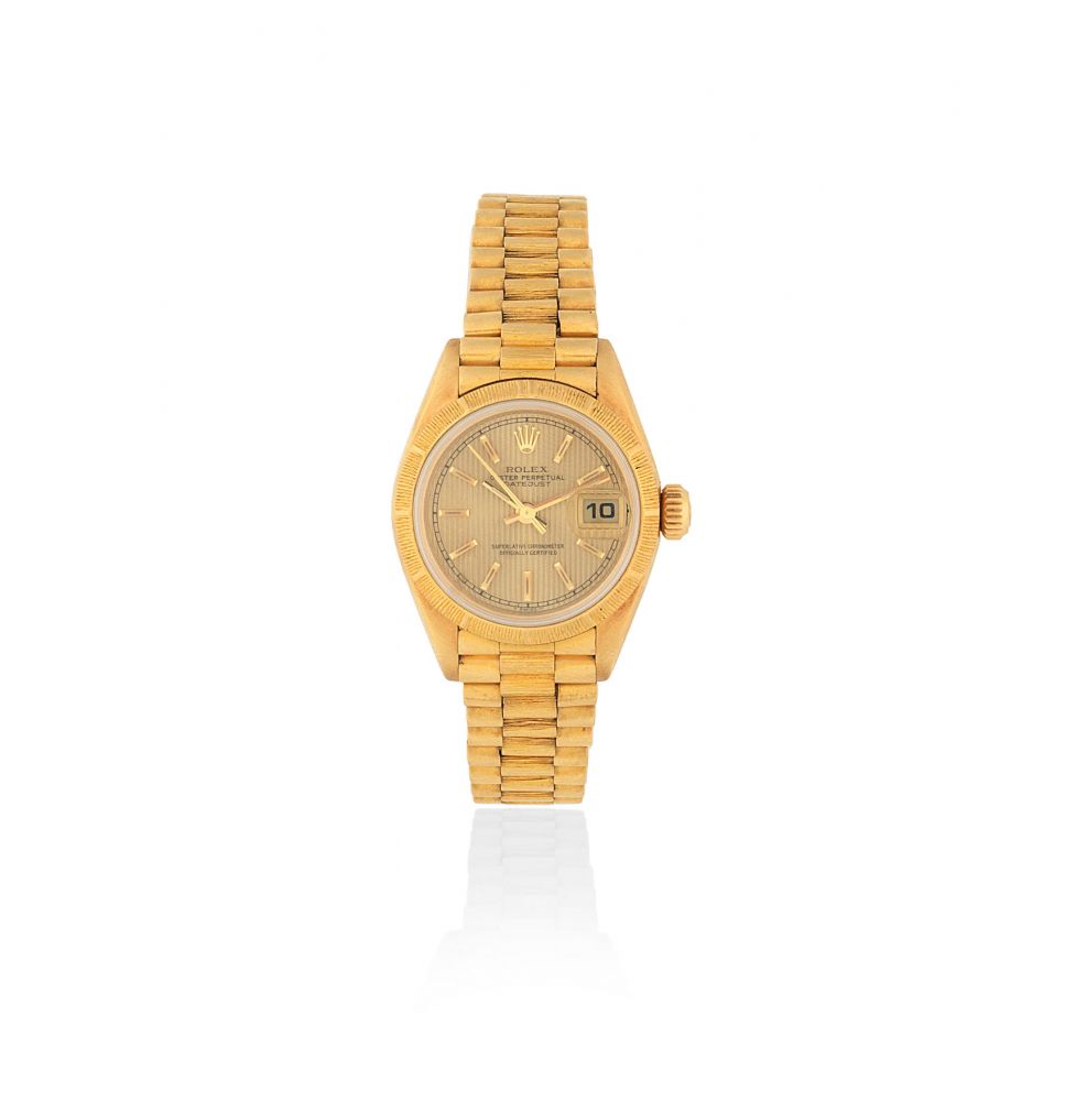 Rolex. A lady's 18K gold automatic calendar bracelet watch