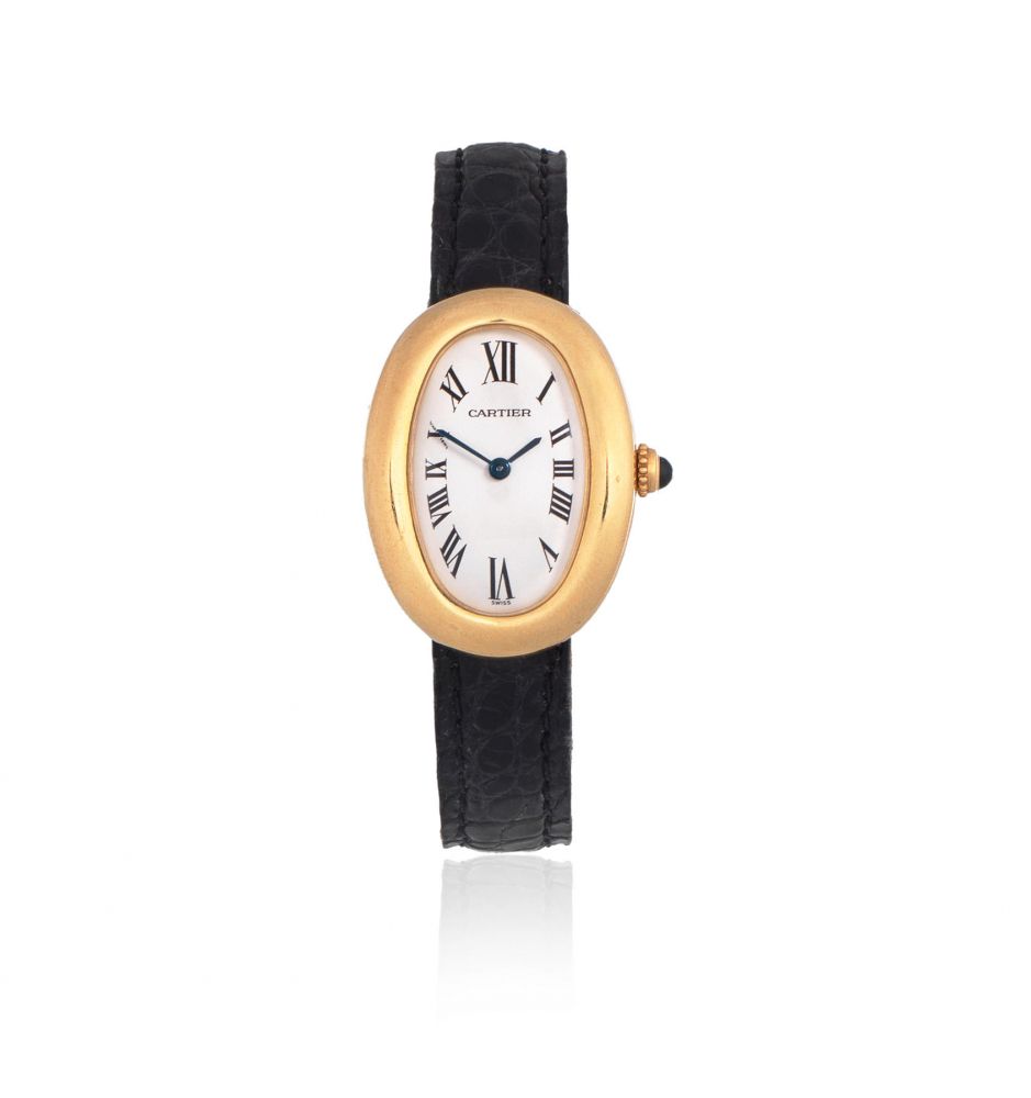 Cartier. A lady's 18K gold quartz oval wristwatch