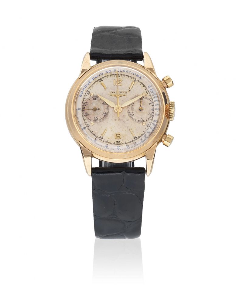 Longines. A 14K gold manual wind flyback chronograph wristwatch