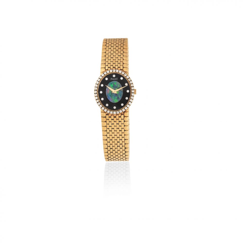 Piaget. A lady's 18K gold and diamond set manual wind bracelet watch with opal dial