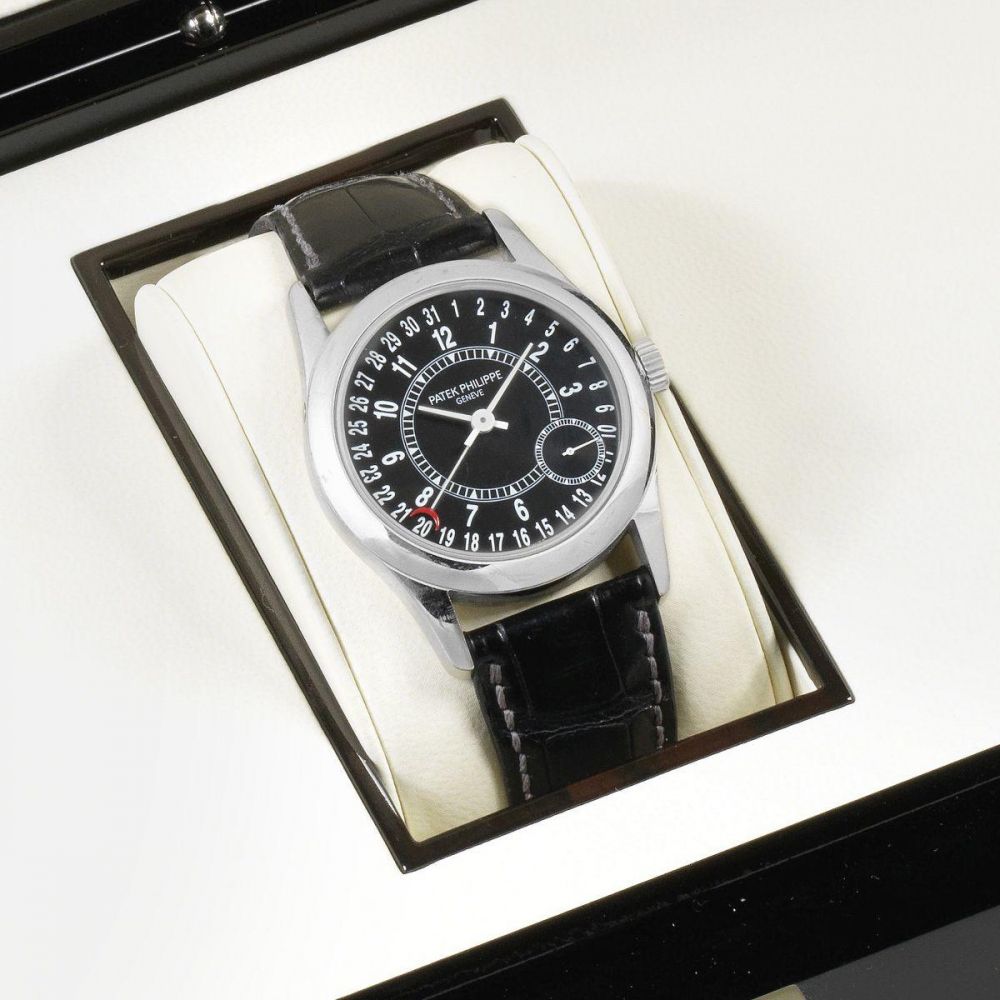 Patek Philippe. An 18K white gold automatic calendar wristwatch