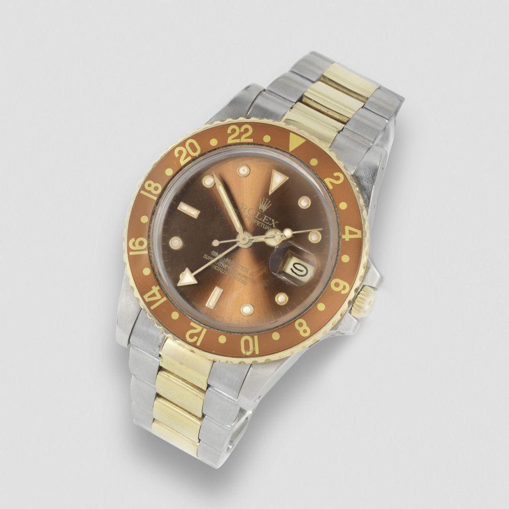 Rolex. A stainless steel and gold automatic calendar bracelet watch with dual time zone