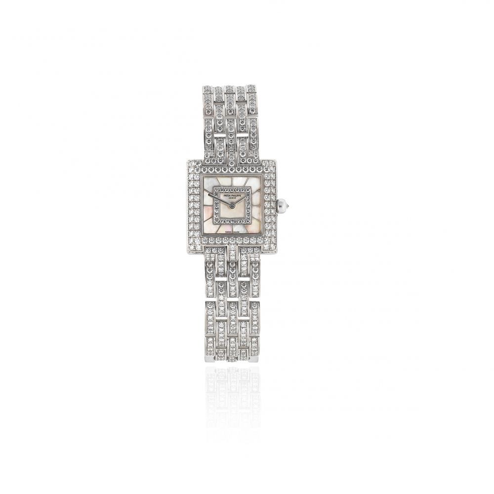 Patek Philippe. A lady's fine 18K white gold, diamond set and mother of pearl quartz bracelet watch