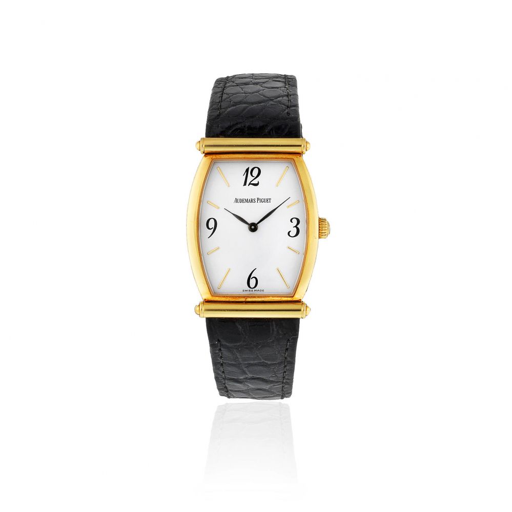 Audemars Piguet. A lady's 18K gold manual wind tonneau form wristwatch