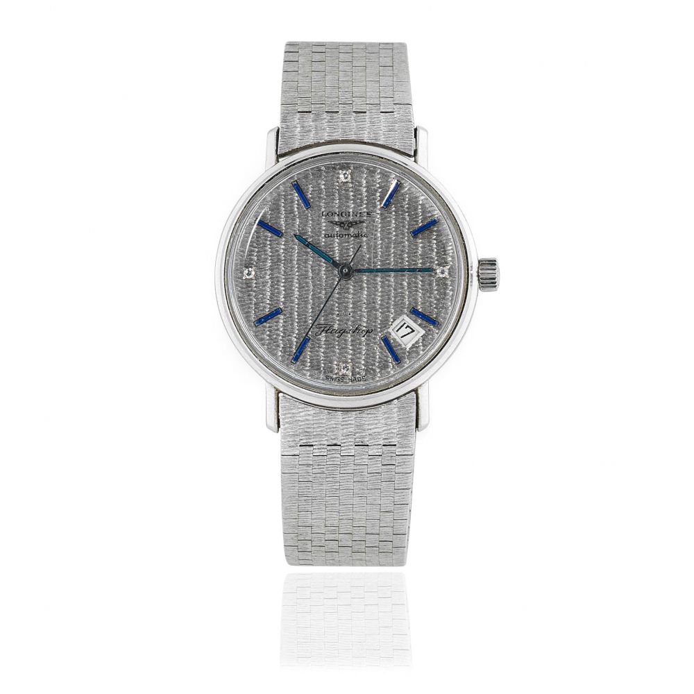 Longines. An 18K white gold automatic calendar bracelet watch