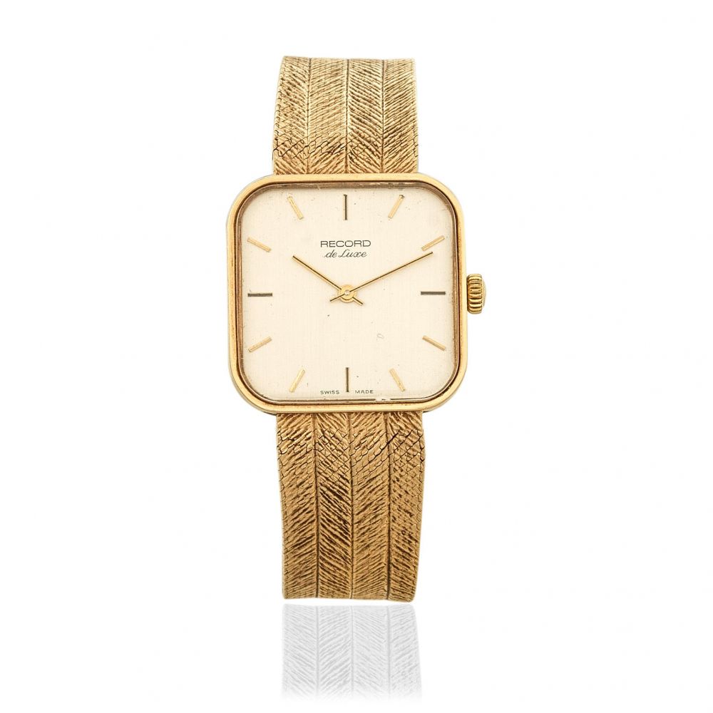 Record. A 9K gold manual wind square bracelet watch