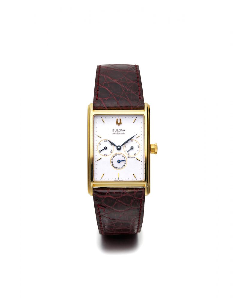 Bulova | A Yellow Gold Rectangular Wristwatch with Date and Power Reserve Indication, circa 2000