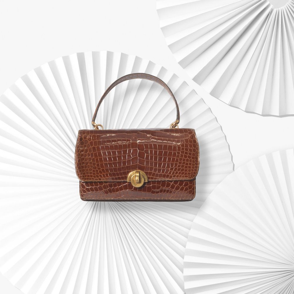 HERMÈS: A BROWN CROCODILE DEMI LUNE HANDBAG