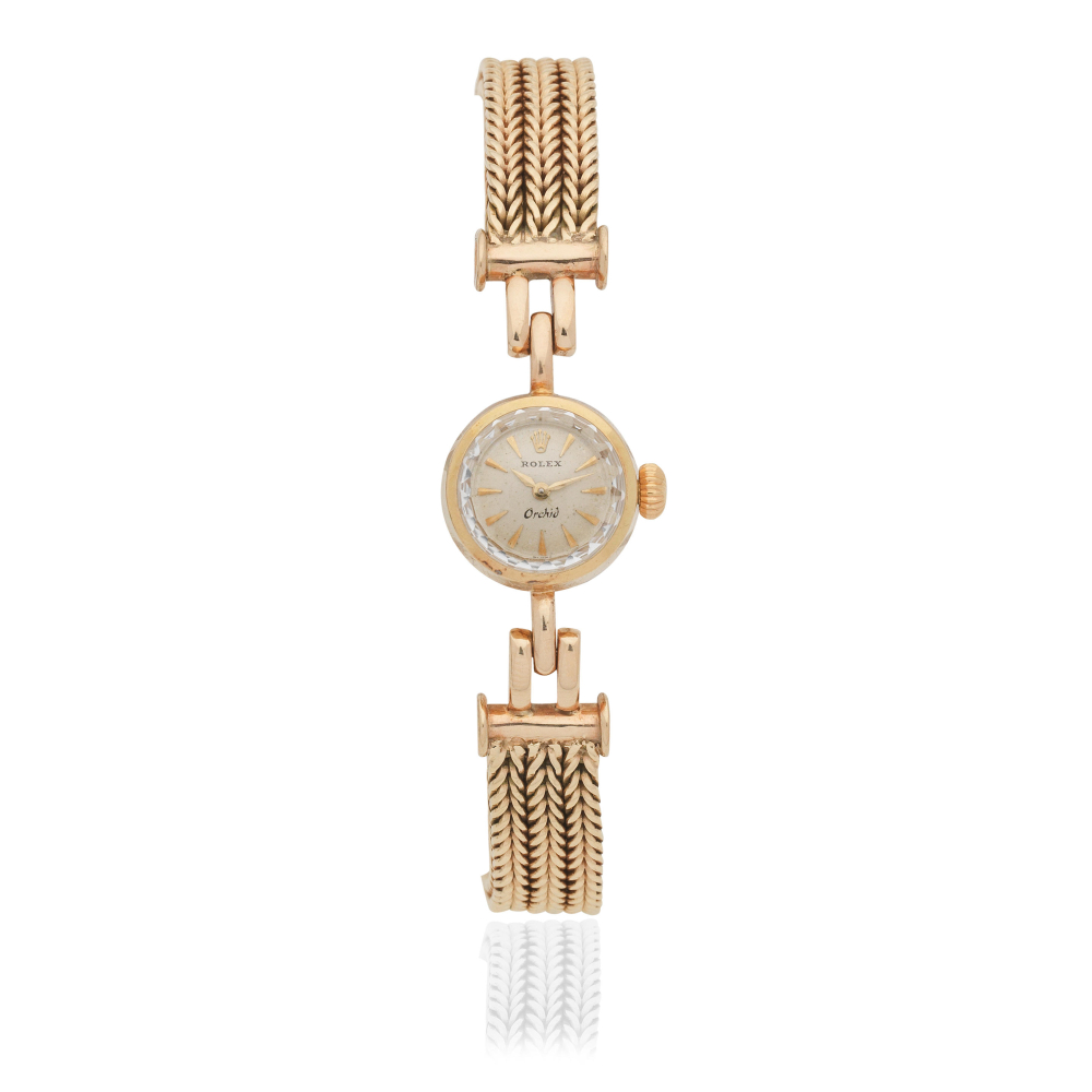 Rolex. A lady's 18K gold manual wind bracelet watch