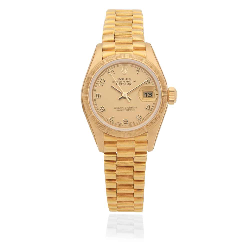 Rolex. A lady's 18K gold automatic calendar bracelet watch