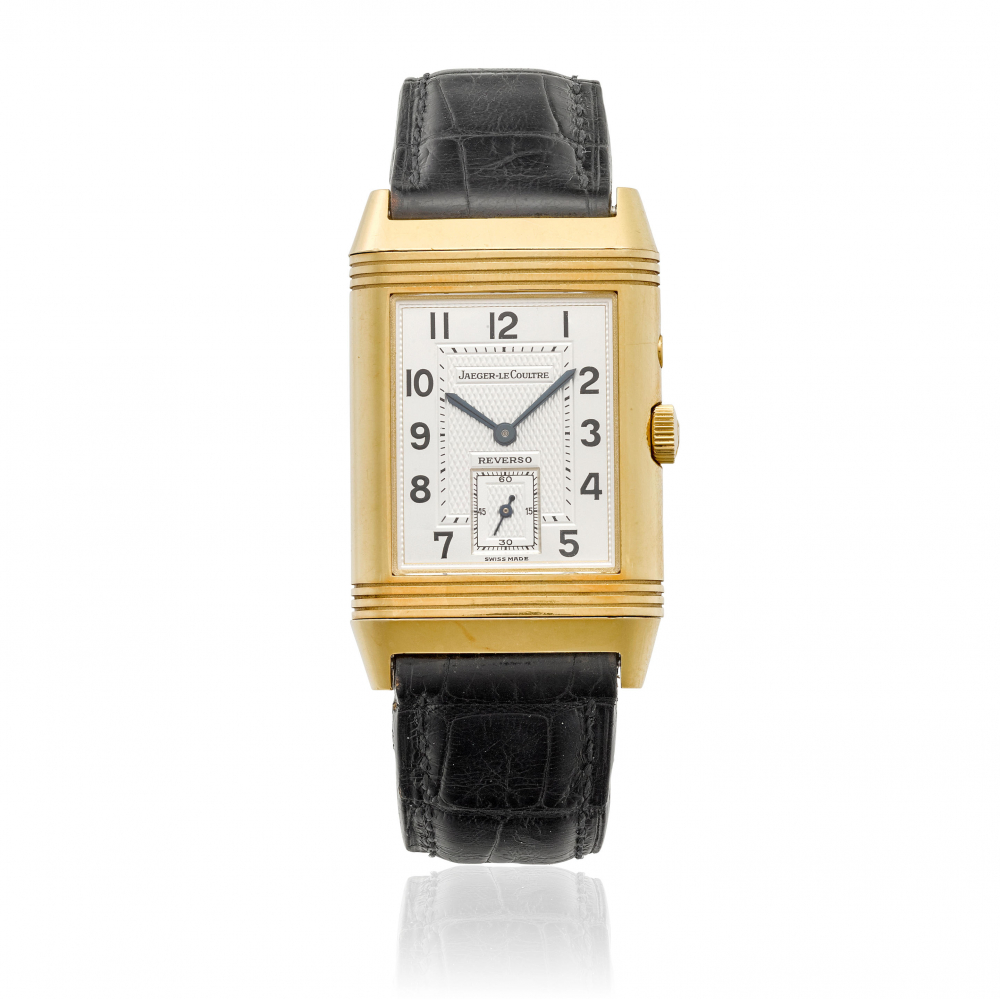 JAEGER LECOULTRE. AN 18K GOLD MANUAL WIND DUAL TIME WRISTWATCH WITH DAY/NIGHT INDICATION