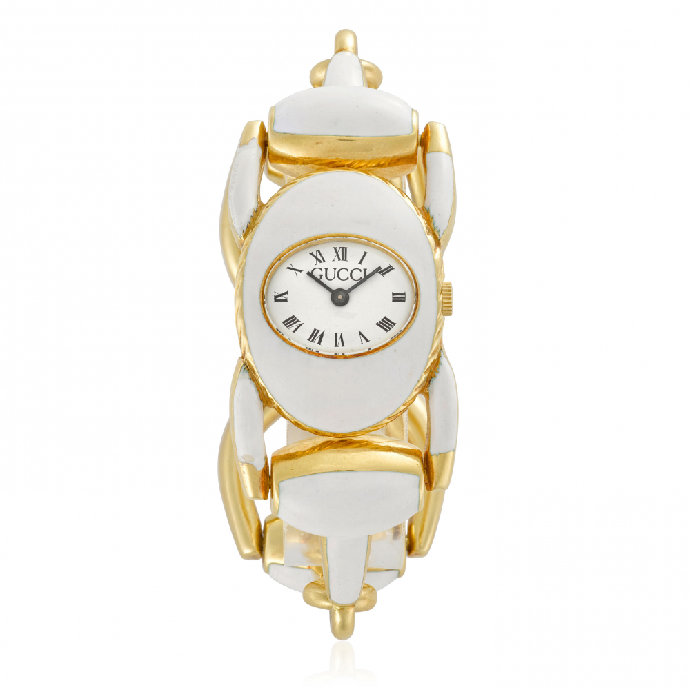 GUCCI. AN ENAMELED GILT MANUAL WIND BRACELET WATCH