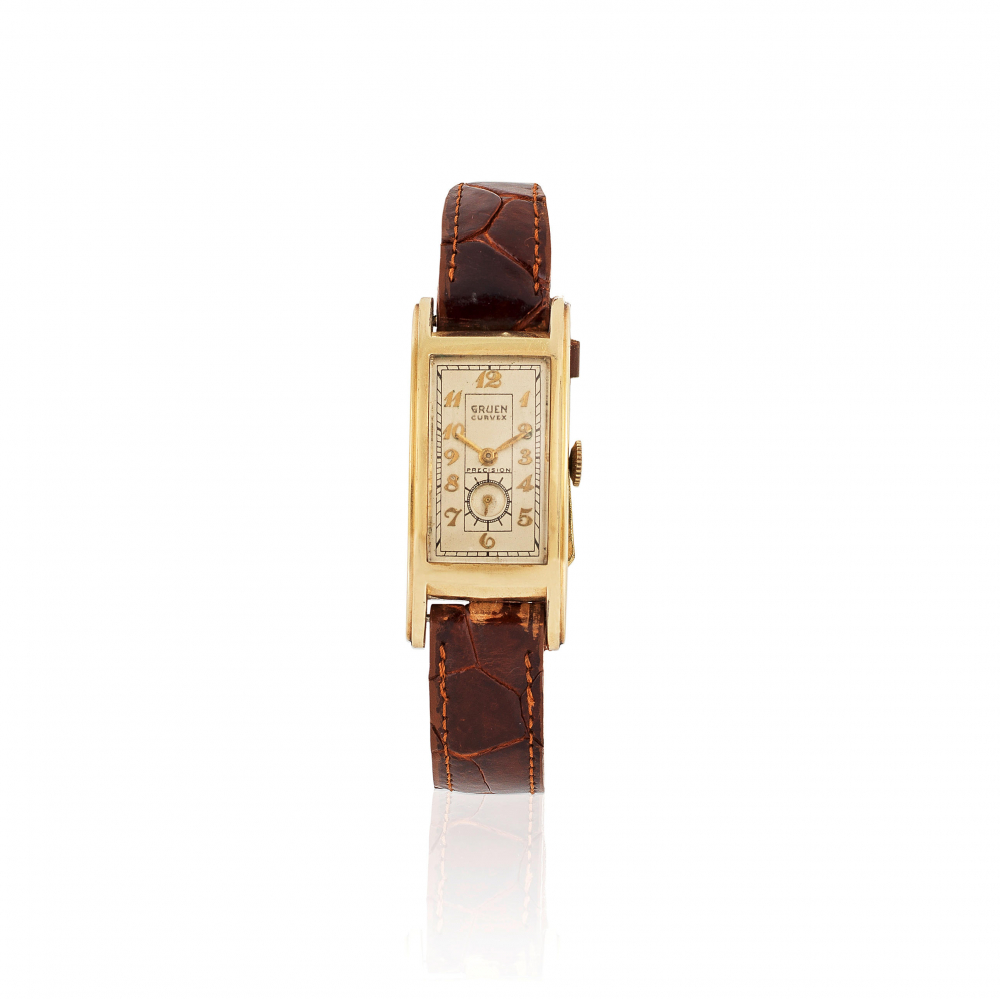 Gruen. An unusual gold plated manual wind curved rectangular wristwatch