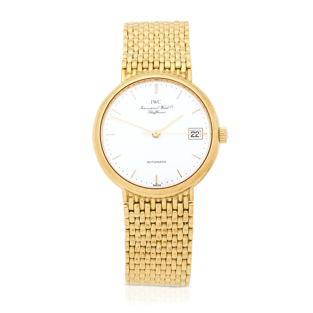IWC. An 18K gold automatic calendar bracelet watch
