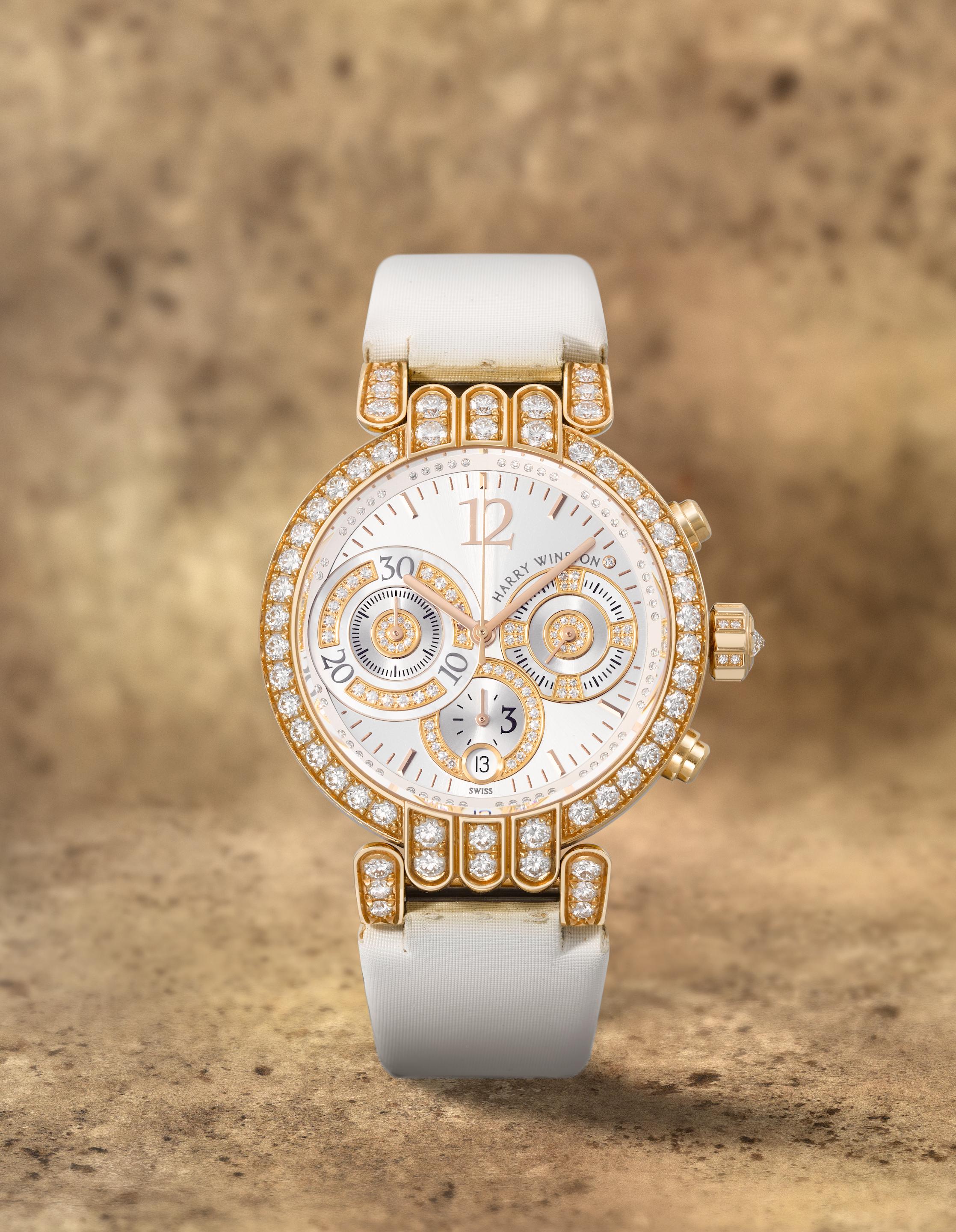 Harry Winston. A fine 18K rose gold and diamond set automatic calendar chronograph wristwatch