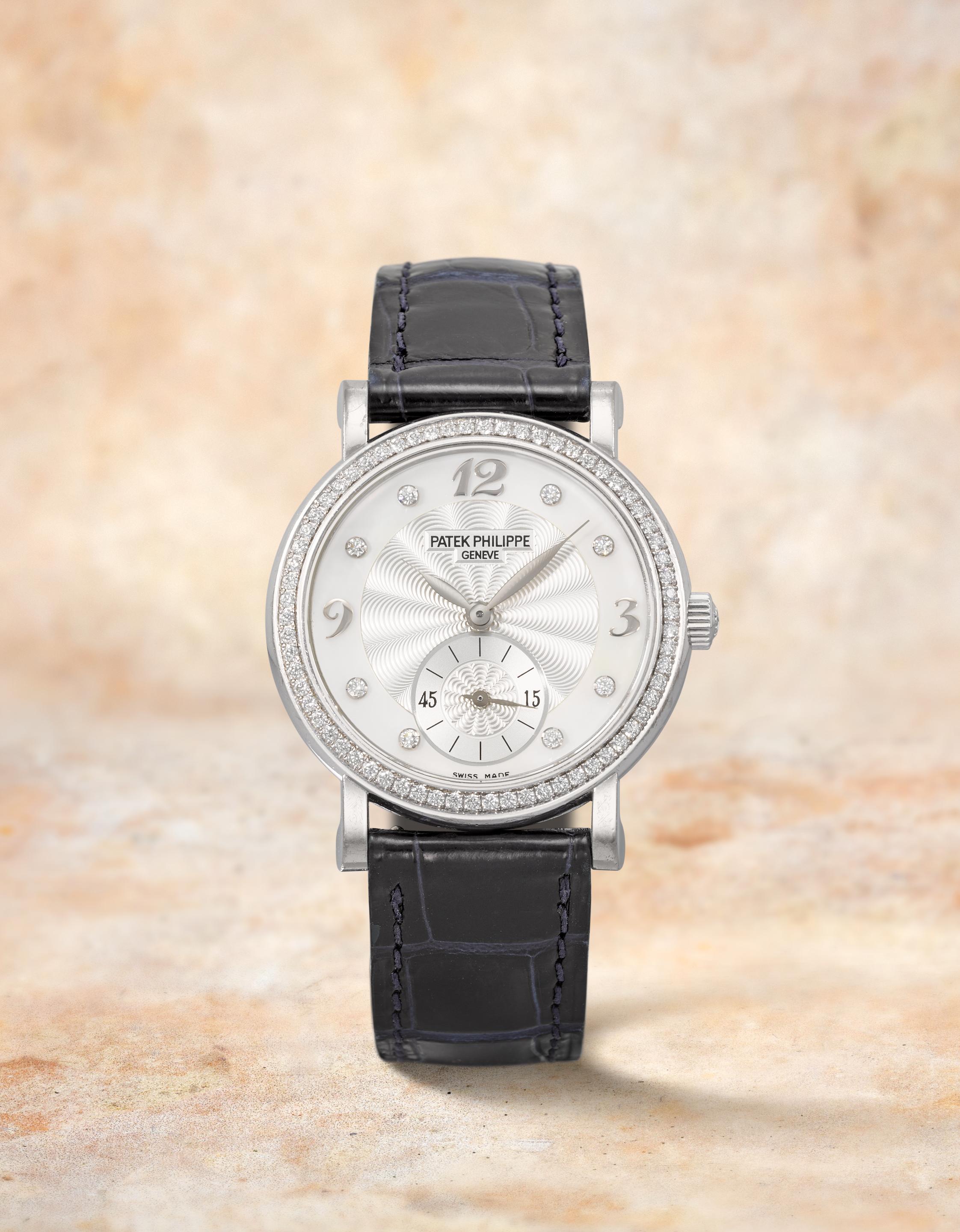 Patek Philippe. A fine lady's 18K white gold diamond set manual wind wristwatch with mother of pearl dial