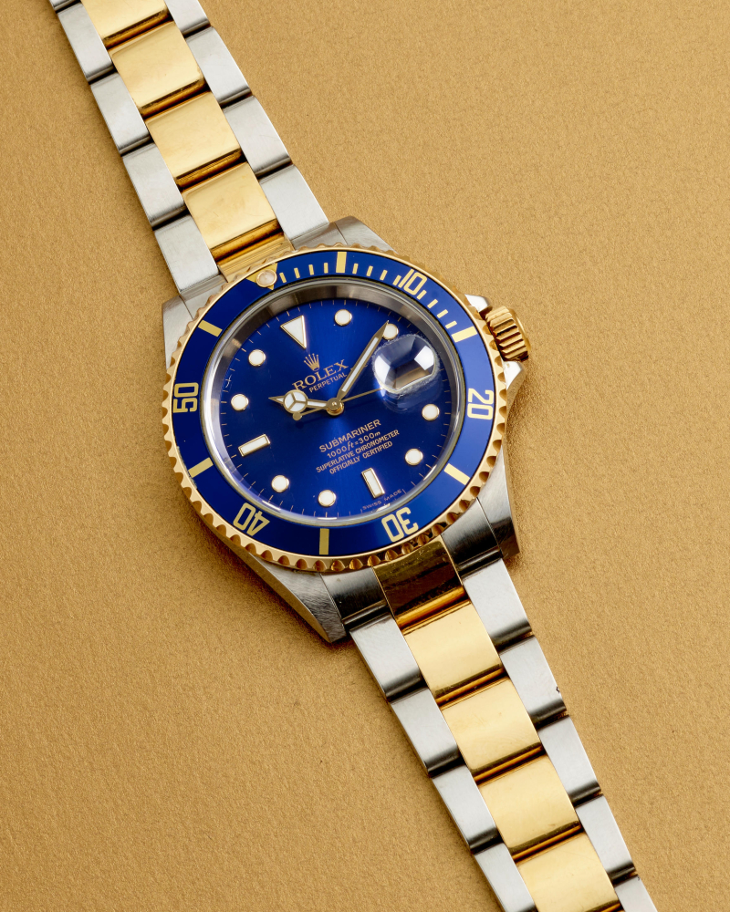 ROLEX. AN 18K GOLD AND STAINLESS STEEL AUTOMATIC CALENDAR BRACELET WATCH