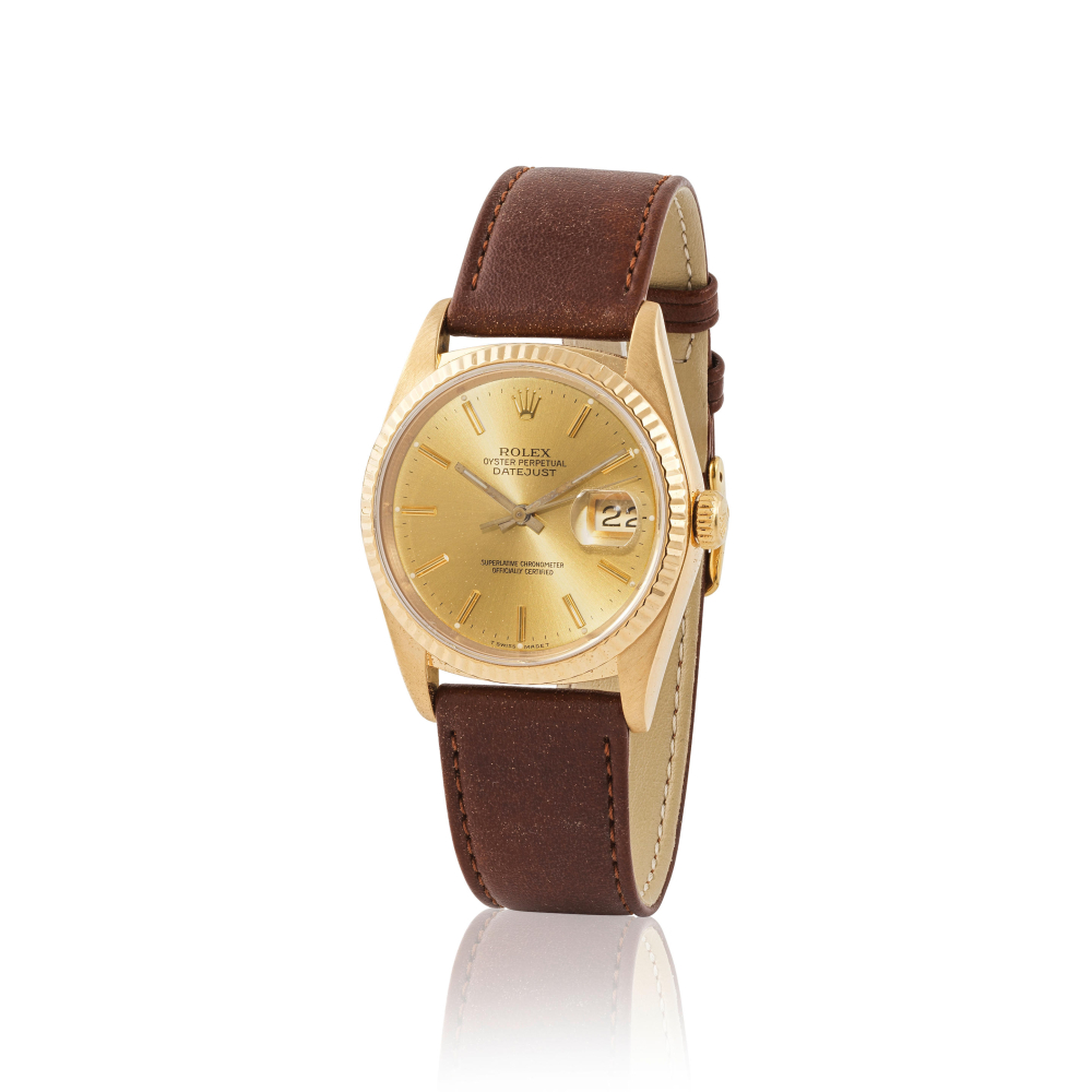 Rolex. An 18K gold automatic calendar wristwatch
