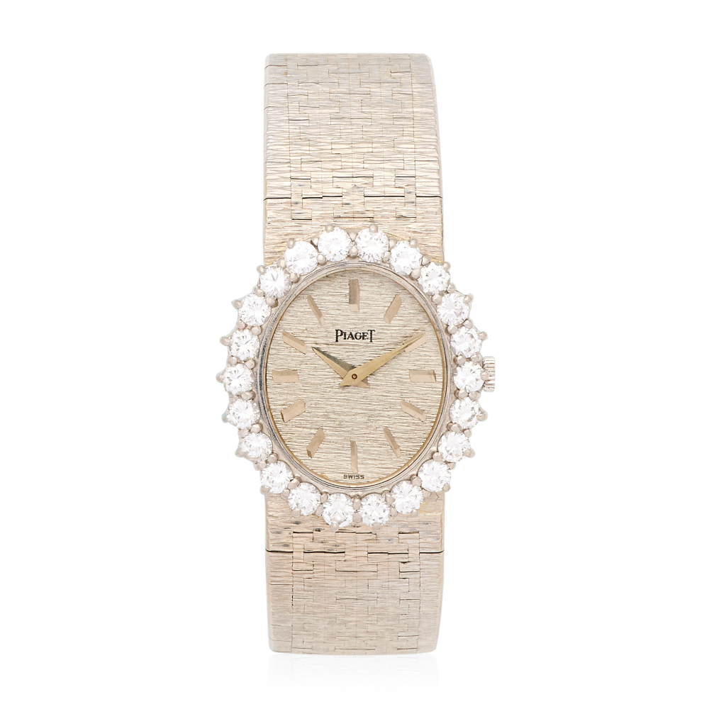 Piaget. A lady's 18K white gold diamond set manual wind bracelet watch