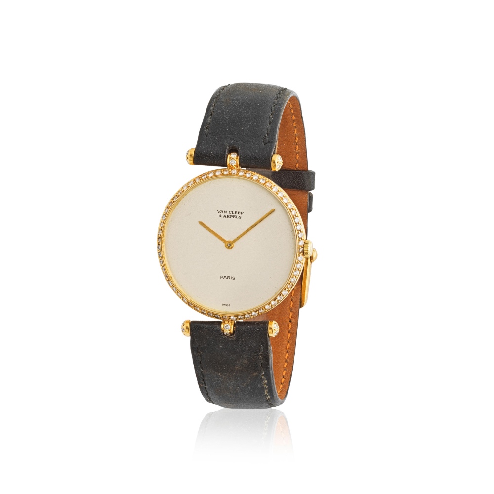 Van Cleef & Arpels. A lady's 18K gold manual wind wristwatch with diamond set bezel