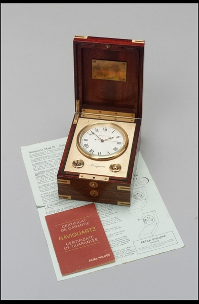 A 20th century brass bound mahoganny quartz timepiece with box and papers