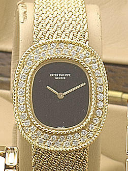 Patek Philippe. A fine 18ct gold and diamond set bracelet watch with original box and papers