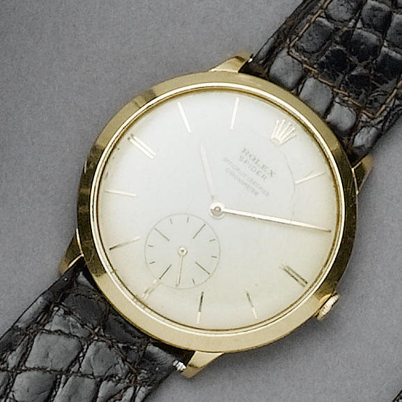 Rolex. An unusual gents 18ct gold wristwatch with a lady's 18ct gold Omega bracelet watch
