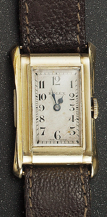Rolex. An unusual 9ct gold mid size flared rectangular wristwatch