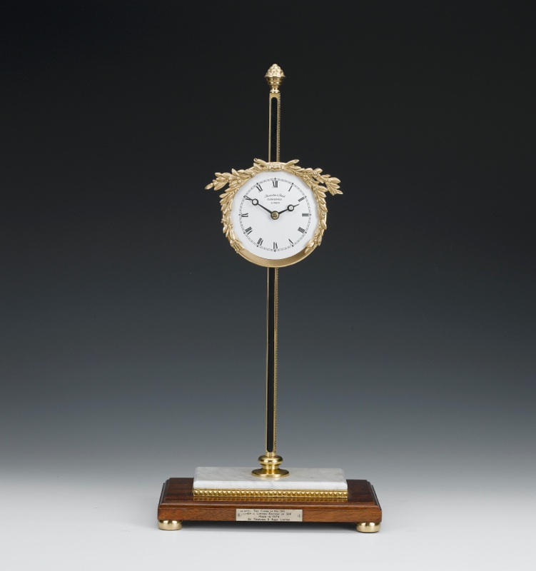 A limited edition brass and marble gravity rack clock