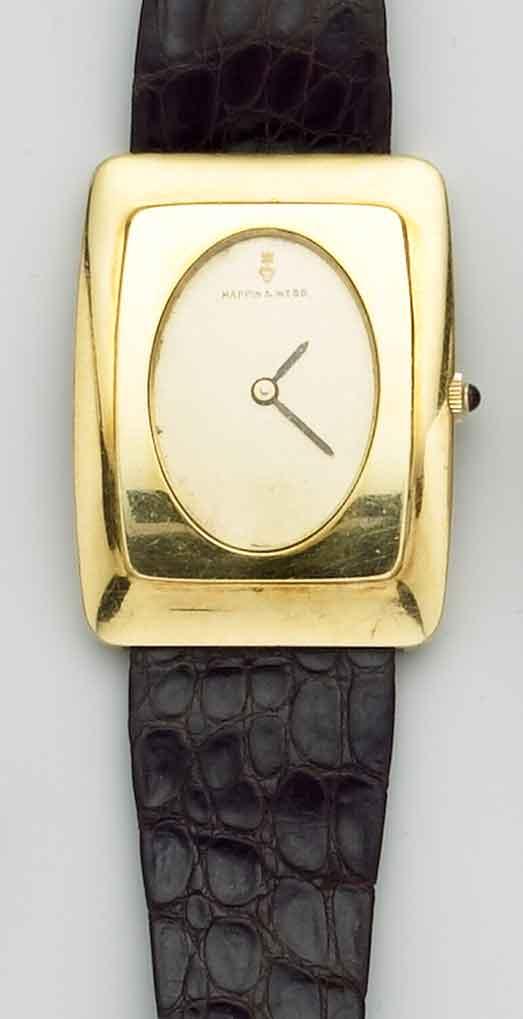 Corum. An unusal 18ct gold wristwatch with factory box