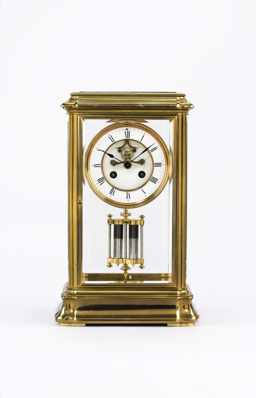 A good turn of the century French lacquered brass four glass mantel clock