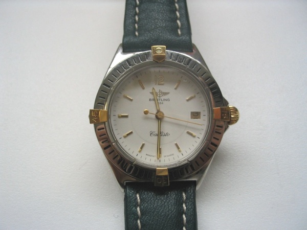 Breitling. A stainless steel and gold calendar bracelet watch