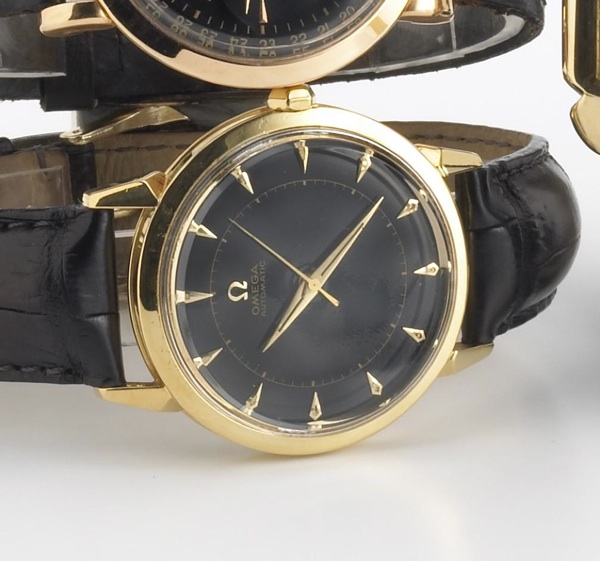 Omega. An 18k gold self-winding wristwatch with black dial