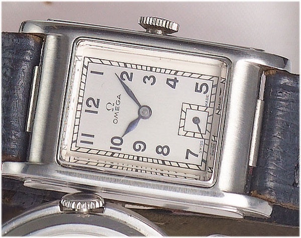 Omega. A stainless steel rectangular water-resistant wristwatch with leather strap and original stainless steel Omega buckle