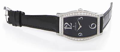 Corum. A Lady's 18k white gold and diamond set curved tonneau shape quartz wristwatch