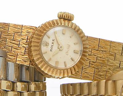 Rolex. A Lady's 18k gold wristwatch with removable 18k gold textured bracelet