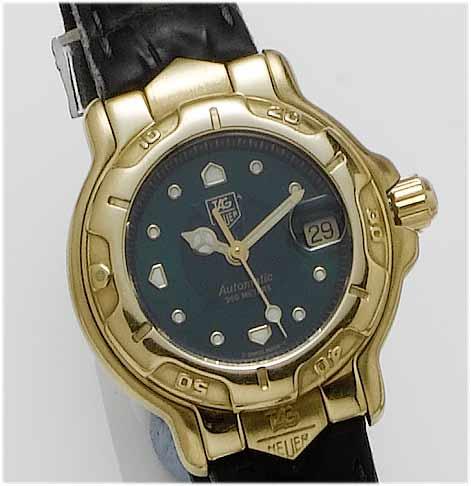 Tag Heuer. A lady's 18ct gold centre seconds calendar wristwatch