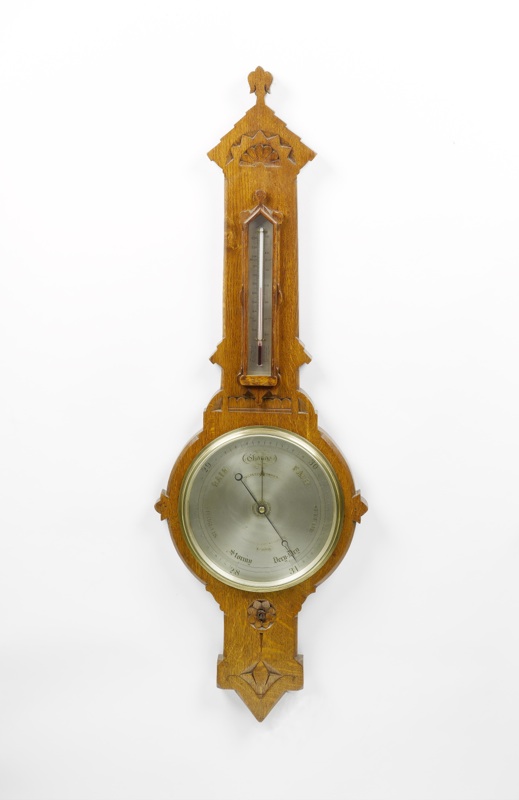 A late 19th century oak cased aneroid barometer