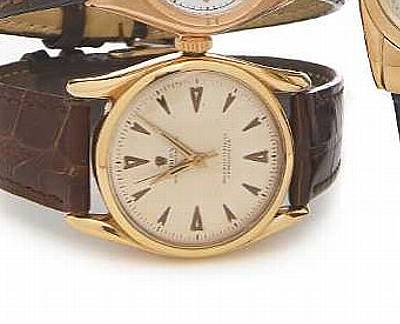 Rolex. An 18k gold self-winding wristwatch with curved shoulders