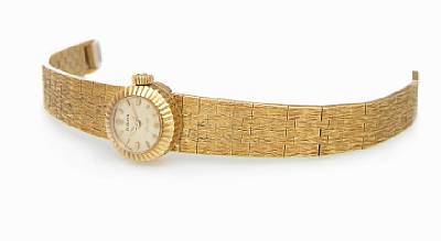 Rolex. A Lady's 18k gold wristwatch with removable 18k gold textured bracelet