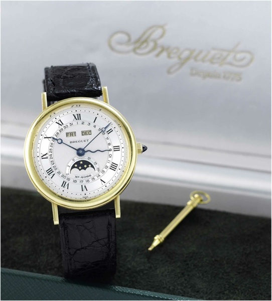 Breguet. A fine 18ct gold astronomic wristwatch with triple date, moon phases, age of the moon and an 18ct gold Breguet buckle together with fitted box and papers