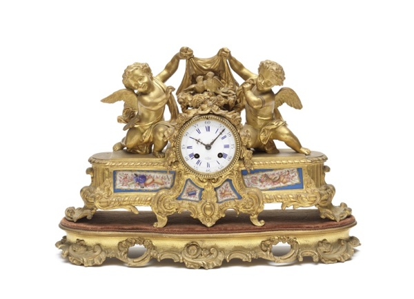 A late 19th century porcelain panelled gilt-brass figural mantel clock