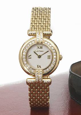 Cartier. A ladies 18k gold and diamond set quartz bracelet watch