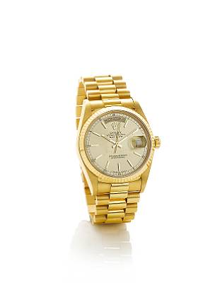 Rolex. A fine 18k gold automatic centre seconds calendar bracelet watch
