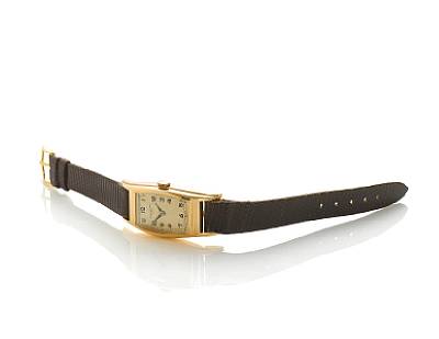 Patek Philippe. A fine 18k rose gold tonneau shape wristwatch in custom made case