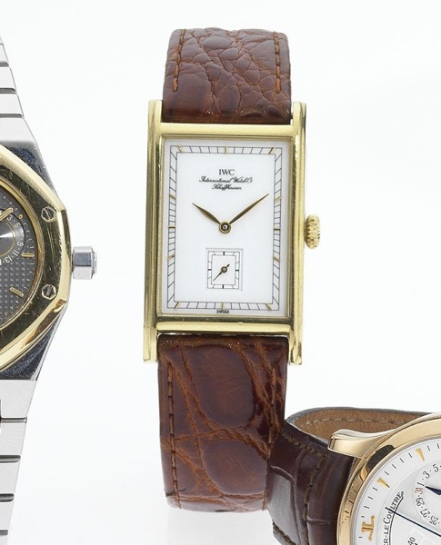 IWC. A fine 18ct gold rectangular wristwatch together with fitted box and papers