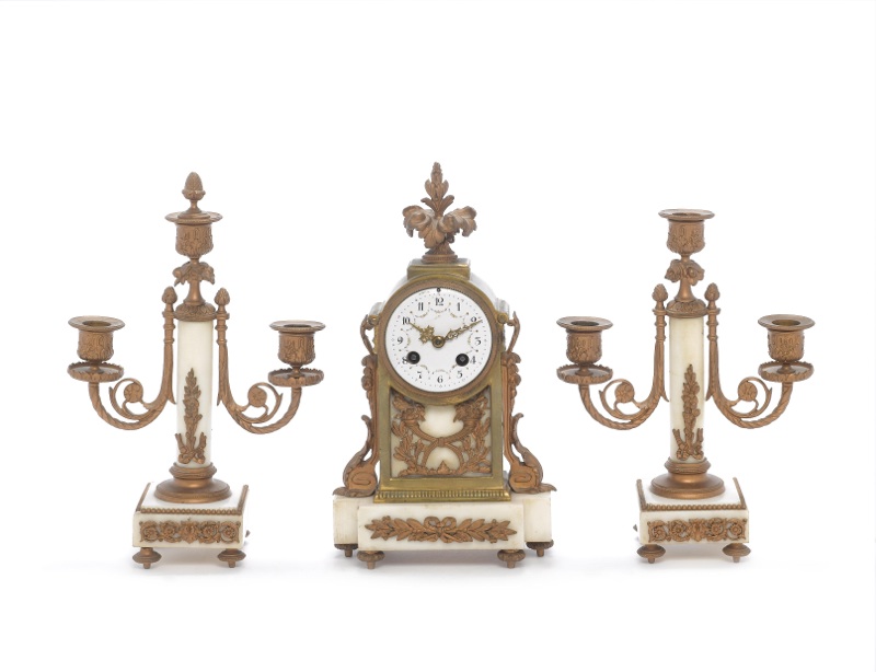 A late 19th century French ormolu and white marble clock garniture